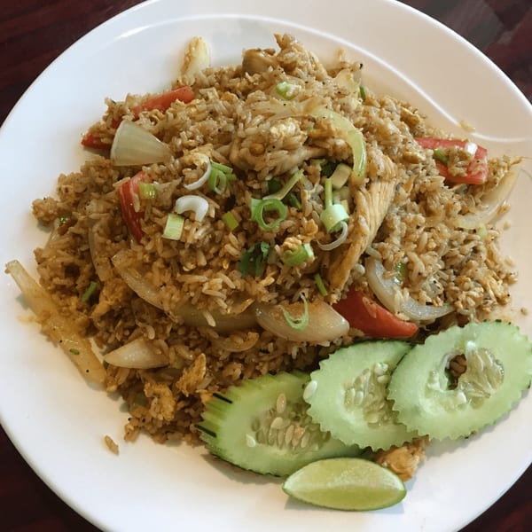Our Thai House's fried rice with chicken, vegetables, and a side of cucumber and lime.
